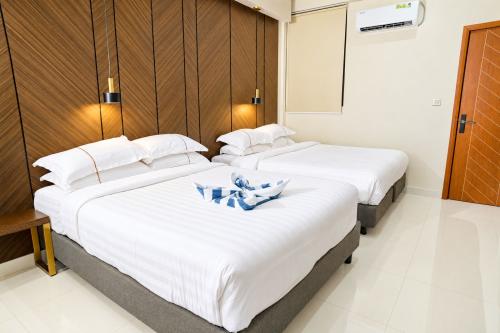 Two double beds side by side in the Deluxe Family Room